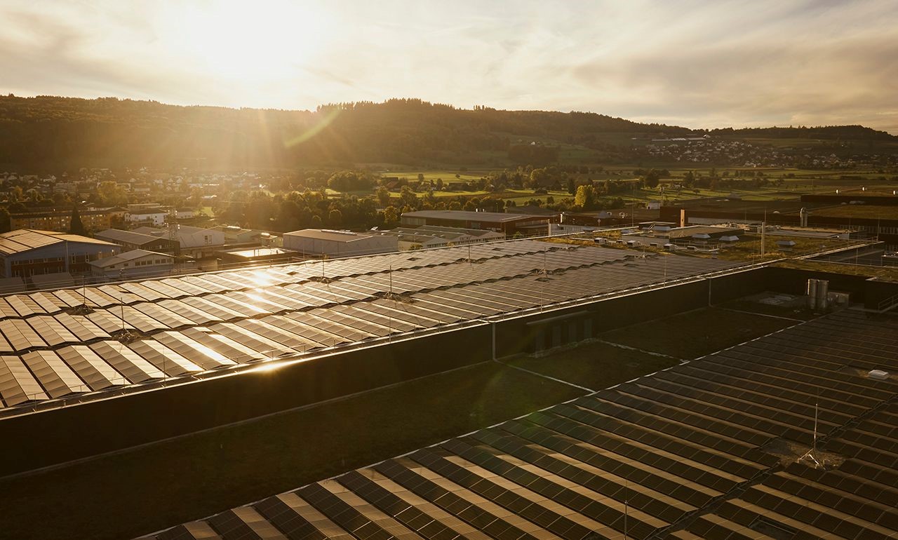 Luftaufnahme der weitläufigen Fotovoltaikanlage auf dem Dach des Logistikzentrums Villmergen. Logistik (USA-Versand) Gesundheitswesen (ePA) E-Voting.